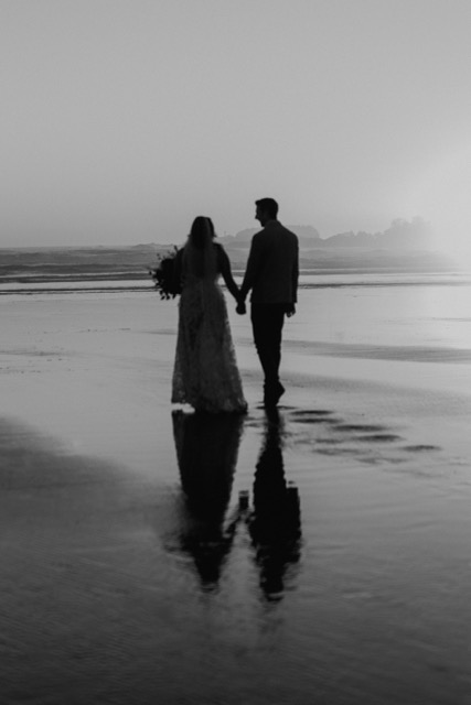 Black and white silhouette of couple on the beach